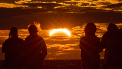 Europe turns skyward as rare solar eclipse sweeps across region (AP image) Moon meets Sun: Millions witness rare solar eclipse as UK sees 90% coverage across Europe