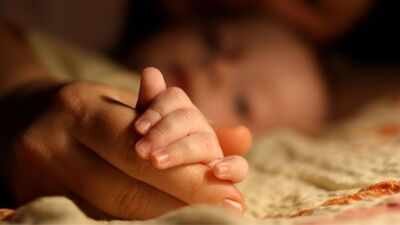 Baby holding mother's hand (Representative Image, Canva) A multi-state surrogacy dispute escalated after McKenna West gave birth in Texas to a baby with a severe heart defect; the intended parents now have custody while the legal fight continues