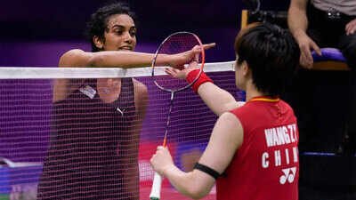 India's PV Sindhu, left, shakes hands with China's Wang Zhi Yi after their match. (PTI Photo) ‘Maybe that was her tactic’: PV Sindhu questions ‘cramps’; Wang Zhi Yi says ‘I was really injured’