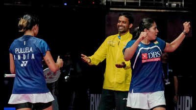 India's Treesa Jolly, front right, and Gayatri Gopichand Pullela, left, celebrate with the latter's father and their coach Pullela Gopichand after winning a women's doubles quarterfinal badminton match against China's Jia Yi Fan and Zhang Shu Xian, unseen, at the BWF World Championships, at IGI Stadium, in New Delhi. (PTI Photo) 'Being Pullela Gopichand's daughter is a big baggage': Coach B Sumeeth Reddy