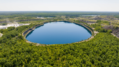 Flooded iron mine pit turned clear lake In 1993, Minnesota turned 5,000 acres of abandoned iron mines and 15 flooded pits up to 525 feet deep into Cuyuna Country; today the former mining landscape has 50+ miles of bike trails and 25 miles of shoreline