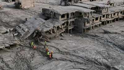 A drone view shows rescue workers inspect the area and damaged structures. (AP Photo) Tea break, visa delay saved pilgrim group from Nepal flood fury