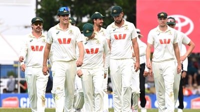 Australian captain Pat Cummins, second left, leads his players from the field following their nine wicket loss to Bangladesh on day four of the first test in Darwin (AP)