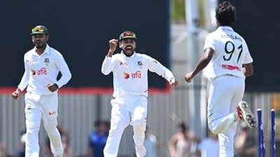 Mehidy Hasan Miraz (centre) celebrates the wicket of an Aussie batsman with his bowler. (James Ross/JAMES ROSS/AAP via AP)