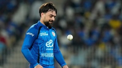 Rashid Khan tosses the ball in the air as he prepares to bowl during a match between Afghanistan and India. (AP Photo/Mahesh Kumar A.)