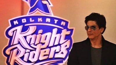 Shah Rukh Khan in front of the KKR logo. (X images) Shah Rukh Khan in front of the KKR logo. (X images)