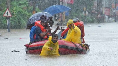 A combined team of NDRF and Fire and Rescue Services evacuates people stranded in floodwaters in an inflatable dinghy at Ranni on Saturday 8 dead as heavy rain wreaks havoc, triggers landslides, floods across Kerala