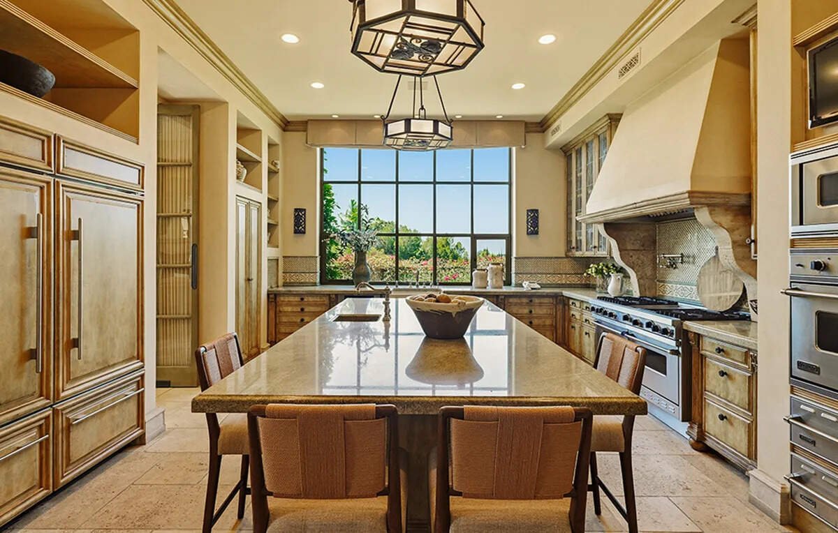 ​A formal dining room with a crystal chandelier is among the highlights of Kaufman’s former Beverly Hills residence.