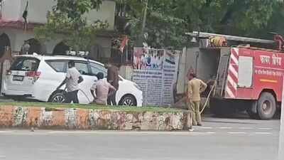 A video shows a government fire brigade vehicle washing a BJP MLA's private car. BJP MLA's private Innova washed by fire brigade, video goes viral