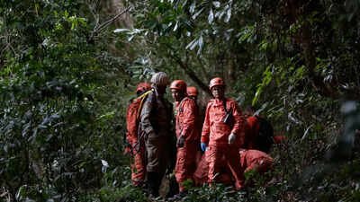 Emergency personnel stand near the site where, according to fire department officials, a helicopter crashed killing the pilot and 3 tourists. (AP Photo) Four killed in helicopter crash in Rio de Janeiro