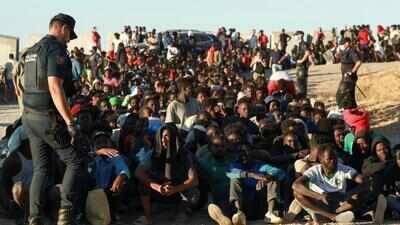 Migrants wait in line to receive food from the Red Cross, following mass crossings of migrants from Morocco into Ceuta, Spain (Picture credit: Reuters) EU eyes tougher border controls after Ceuta migrant surge triggers alarm