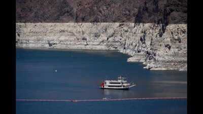 A paddle boat in Lake Mead near the Hoover Dam, far below the bathtub ring of light minerals indicating the lack of water, near Boulder City, Nev., on Friday, Aug. 7, 2026. (AP Photo/Ty ONeil) Lake Mead fell to 1,040.4 feet as the Colorado River crisis deepened; Lake Powell is also under pressure, raising questions over water and hydropower