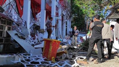 Police officers inspect a damaged building following an earthquake in Manado, North Sulawesi, Indonesia. (AP image) Indonesia earthquake: Several killed, buildings collapse, multiple tremors recorded - top developments