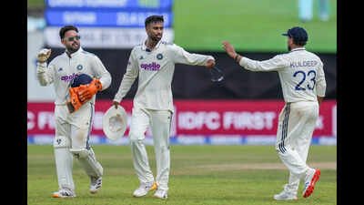 India's Manav Suthar, centre, celebrates with Kuldeep Yadav, right, and Rishabh Pant after taking the wicket of Sri Lanka's Lahiru Kumara. (PTI Photo) IND vs SL 1st Test: Suthar, Jadeja spin India into commanding 178-run lead over Sri Lanka in Galle