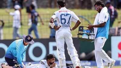 Sri Lanka's Sonal Dinusha, assisted by a support staff member, on the third day of the second test match between India and Sri Lanka at the Sinhalese Sports Club Ground, in Colombo on Tuesday. (ANI) India vs Sri Lanka: The good, old grind takes centrestage in Colombo
