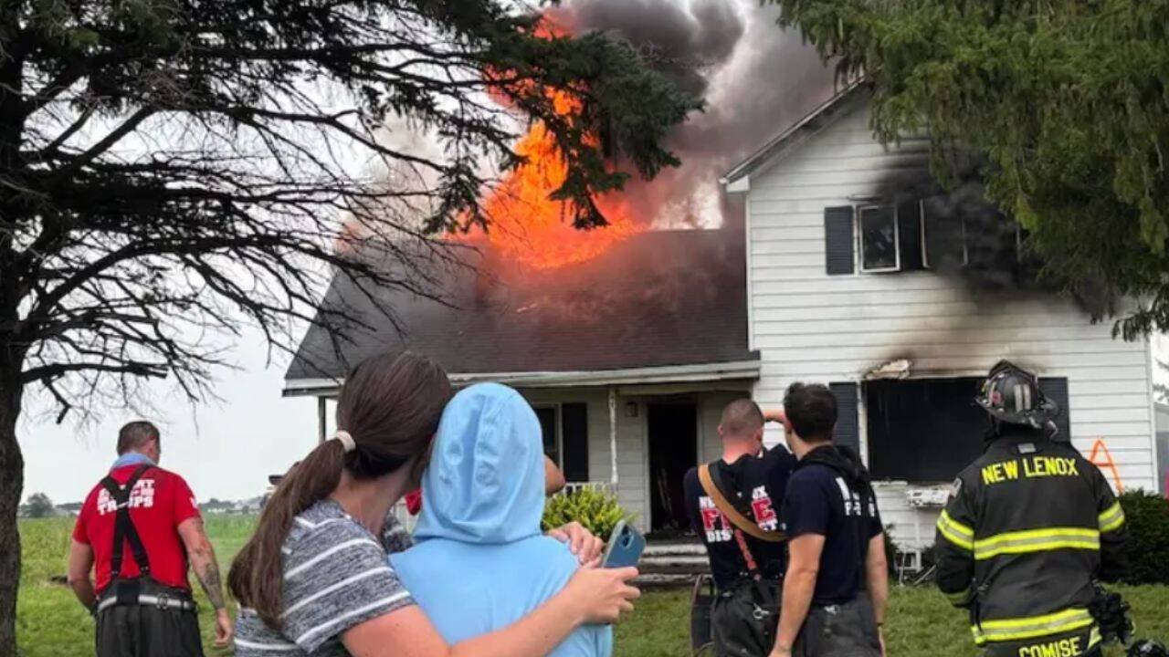 Meghan Keating (left) stands with her mother, Karen Kestel, as their family's four-generation farmhouse is burned