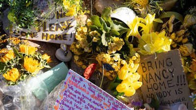 FILE - A collection of yellow flowers and notes sit at the home of Nancy Guthrie, the missing mother of "Today" show host Savannah Guthrie Savannah Guthrie begs public after mother's disappearance; ransom note said 'buried in nature'