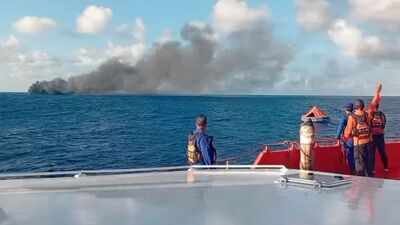 Smoke from the passenger ferry that caught fire while traveling from the tourist island of Bali to neighboring island of Lombok, AP Passenger ferry catches fire near Bali; 106 rescued, 25 still trapped