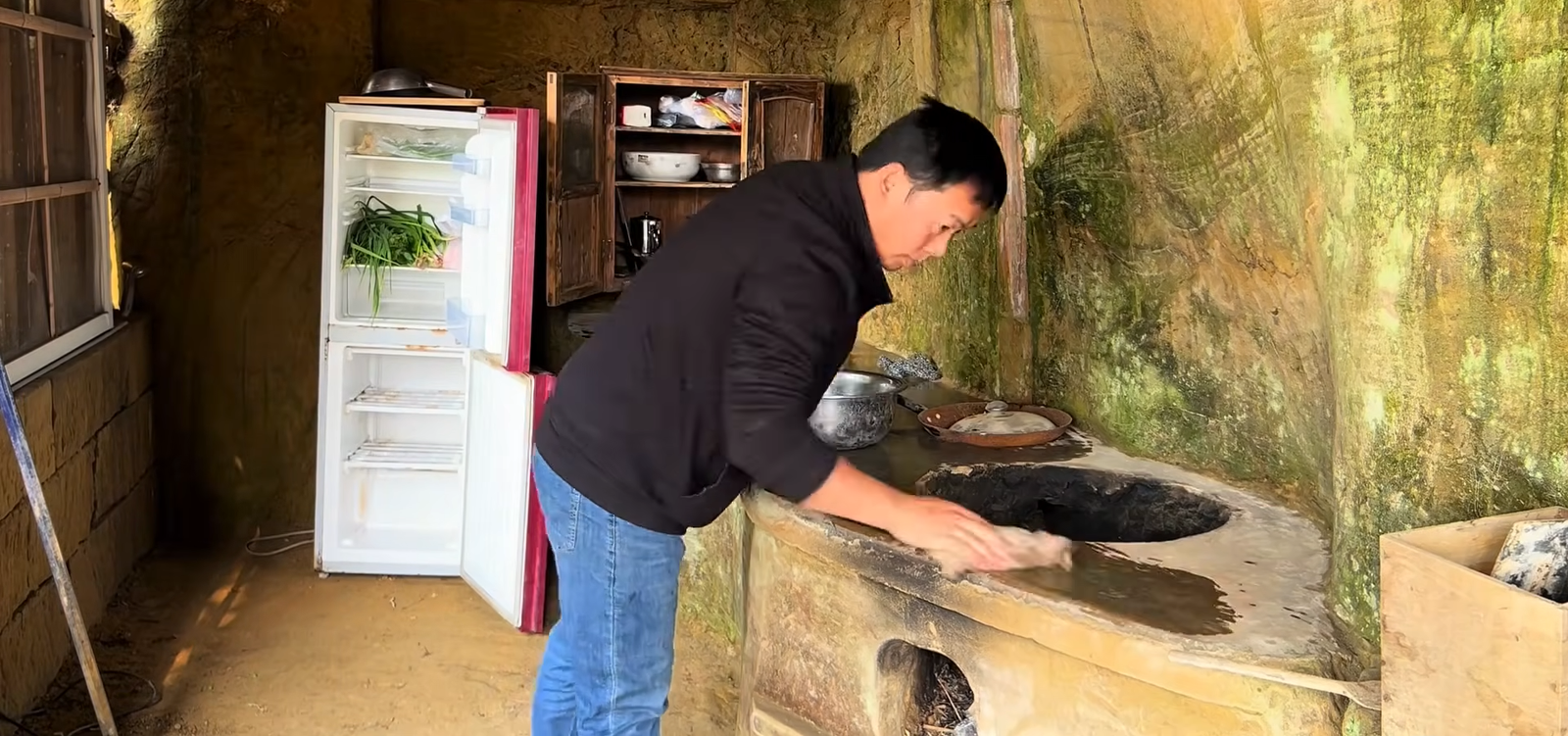 The kitchen is carved directly into the mountain, with rock-cut counters and built-in features designed to make the remote home fully functional.