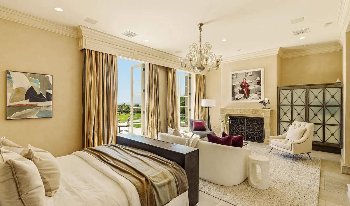 The primary suite features dual walk-in closets and bathrooms, adding to the estate’s luxurious appeal.
