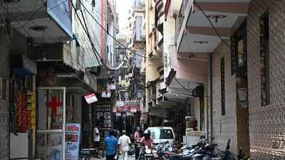 In Noida’s PG belt, buildings rise nine floors where two are allowed, cables dangle at arms reach