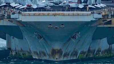 A weathered and rusted USS Abraham Lincoln docks in Thailand for maintainance Rust streaks, faded paint and 5,000 tired sailors: War-weary USS Lincoln docks in Thailand