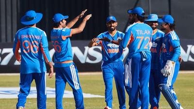 TOPSHOT - Indian players celebrate the wicket of Brian Bennet during the second Twenty20 international cricket match between Zimbabwe and India at Harare Sports Club in Harare, on July 25, 2026. (Photo by Jekesai NJIKIZANA / AFP) (AFP)