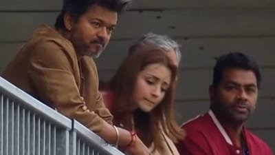 Vijay, Trisha Krishnan and Aadhav Arjuna on stands at Ajith Kumar's Le Mans race.