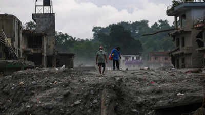 People walk next to damaged buildings following the deadly flash floods and mudslides in Devighat, Nuwakot district, Nepal (Picture credit: Reuters) ‘Developed countries must take lead': India calls for climate finance after Nepal flood