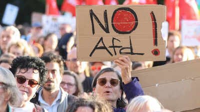 Demonstrators hold banners during a protest after AfD's victory, in Berlin. Thousands protest in Germany as far-right AfD eyes first state government since the Nazi Party