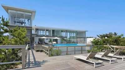 A Fire Island glass house drew 350+ viewers at $5.25 million but no buyer; after $1.255 million in cuts, its $3.995 million ask is still nearly $1.3 million above Cherry Grove's record sale