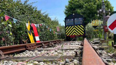 A retired UK rail engineer turned his East Sussex garden into a working railway using a Victorian platelayer’s trolley; the line now runs 50 feet and uses a 12-volt battery charged by solar power