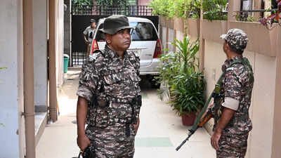 Security personnel stand guard as Enforcement Directorate (ED) officials conduct searches at the residence of former West Bengal minister Indranil Sen PMLA case: ED searches ex-Bengal minister Indranil Sen’s premises, 14 others