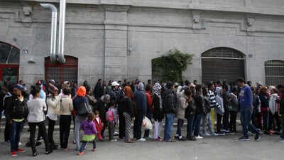 File photo: Migrants queue to enter a refectory in Milan, Italy (Picture credit: AP) Five EU countries move towards first ‘return hub’ for rejected asylum seekers