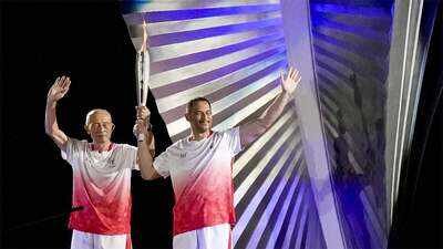 Father Shigenobu Murofushi and son Koji Murofushi (Reuters Photo) Father-son duo makes history: Five-time Asian Games champion Shigenobu Murofushi and Olympic gold medallist son Koji light cauldron in Aichi-Nagoya