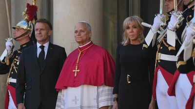 Pope Leo XIV, center, is welcomed by French President Emmanuel Macron, left, and his wife Brigitte ‘Leo, Leo’ chants echo across Paris as 800,000 attend Pope Leo’s mass