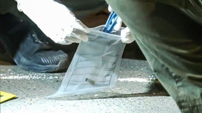 A forensic team collects samples from the spot where shots were fired at actor Tiger Shroff in Mumbai on Sunday. The actor is safe and has not sustained any gunshot injuries. (ANI Video Grab)
