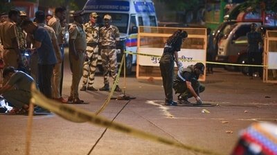 A forensic team collects samples from the spot where shots were fired at actor Tiger Shroff, in Mumbai on Sunday. Actor is safe and has not sustained any gunshot injuries. (ANI Photo)