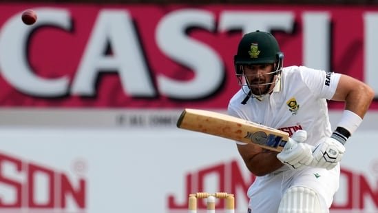 South Africa's Aiden Markram looks on as the ball evades the fielder.