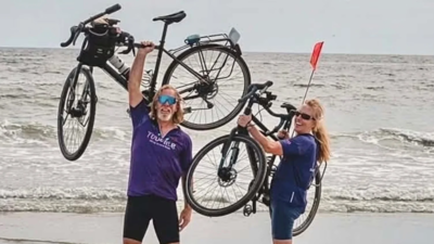 A Utah couple began cycling across America on their 40th wedding anniversary; 87 days and 3,634 miles later, they reached the Atlantic coast and raised about $23,000 for two community charities