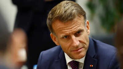 French President Emmanuel Macron walks with Mayor of Trappes Ali Rabeh as he arrives for a meeting at the town hall. ‘A racist terror attack’: French President Macron condemns deadly shooting near Paris