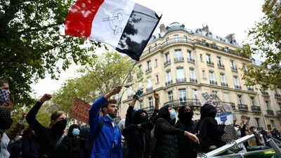 A protester holds a French flag behind a barricade to block the Boulevard Saint-Germain during a blockade of Sciences Po university in Paris. From France to Italy, Belgium to Greece, student protests spread across Europe