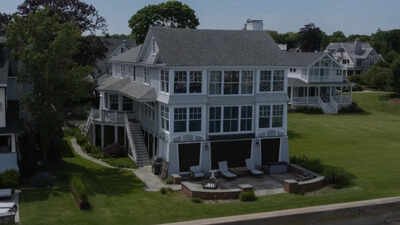 The contemporary residence has been designed to make the surrounding water visible from nearly every room A glass-wrapped Connecticut waterfront home with views of Long Island Sound went to auction with bidding starting at $2.1 million; the lighthouse-inspired house sits directly on the shoreline