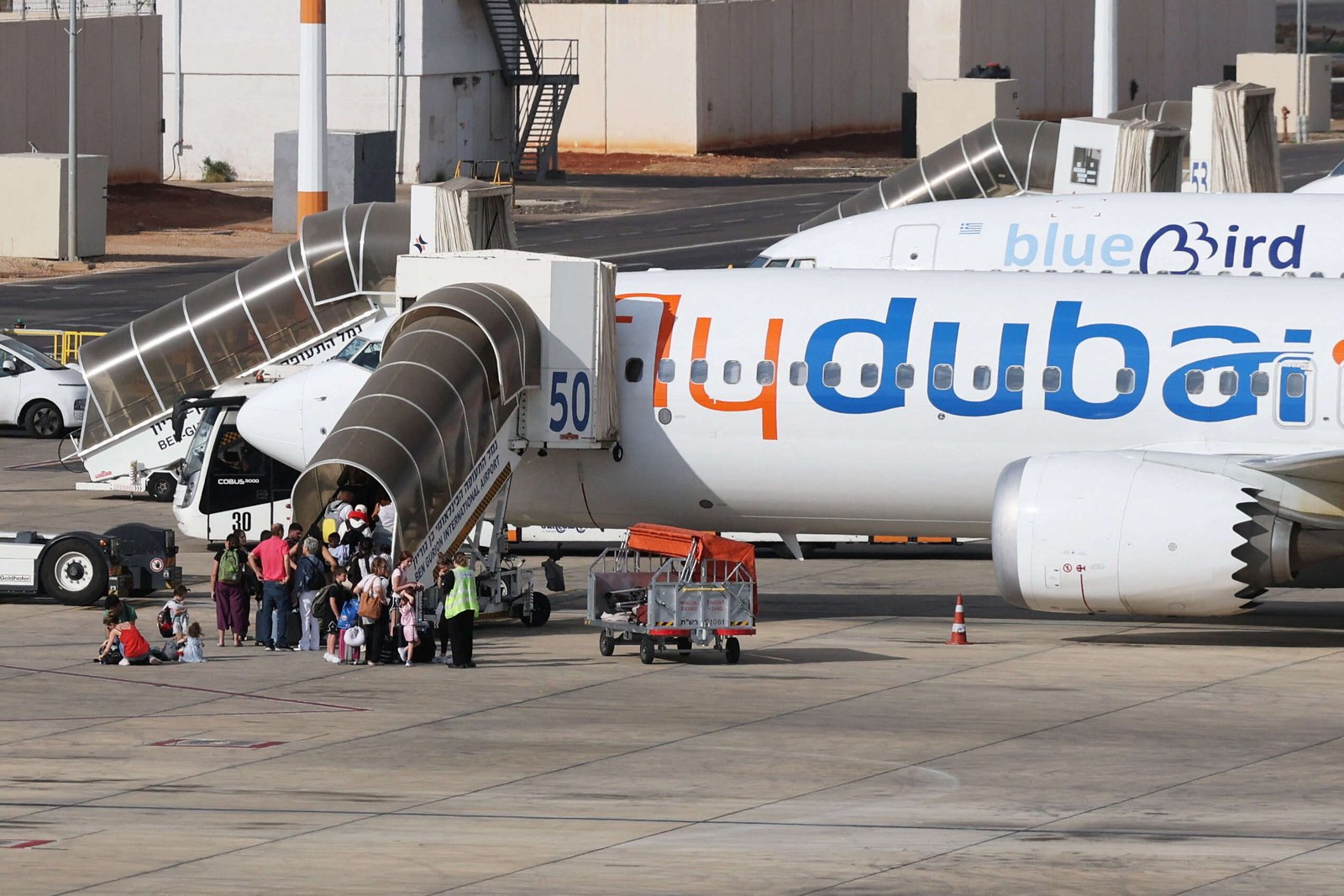 Travelers board a FlyDubai aircraft at Ben Gurion International Airport after a separate FlyDubai flight from the United Arab Emirates to Israel was diverted to Saudi Arabia following an emergency
