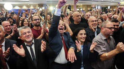 File photo: Yousef Jabareen, leader of Israel's Arab-led Joint List political alliance, (Centre-L) and other members cheer at the alliance's campaign headquarters Arab parties claim kingmaker status in Israel